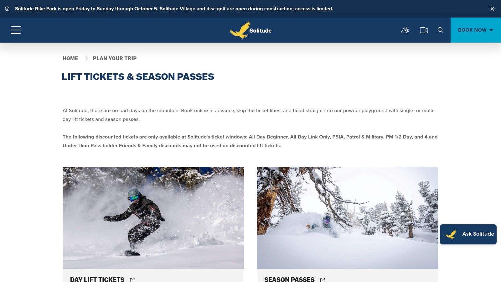 Groomed ski run at Solitude Mountain Resort on a sunny day, with the resort village visible at the base.