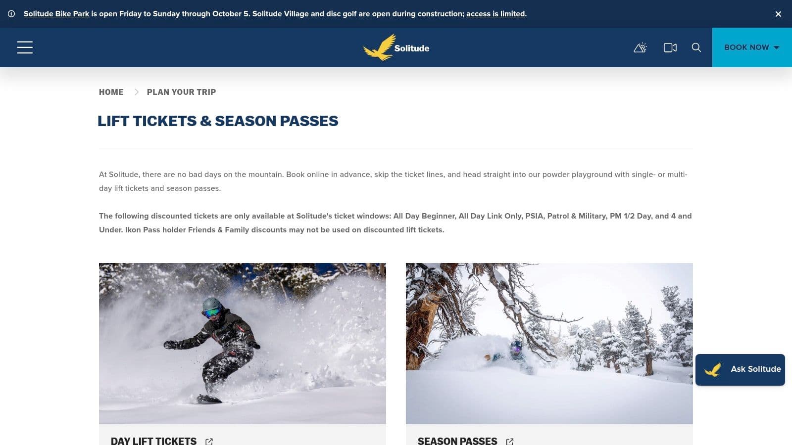 Groomed ski run at Solitude Mountain Resort on a sunny day, with the resort village visible at the base.